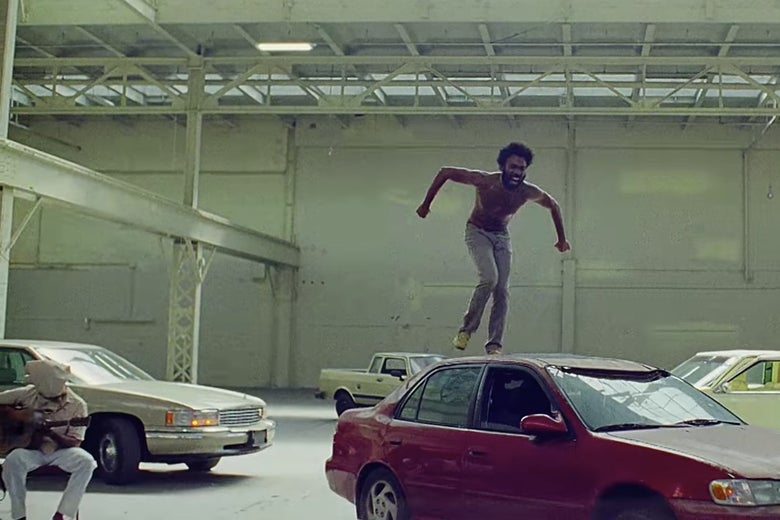 Childish Gambino (Donald Glover) stands on top of a car in the "This Is America" video.